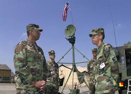 US Army Private First Class Joe Contreras, from 5th Signal Command, briefs  US Army Major General