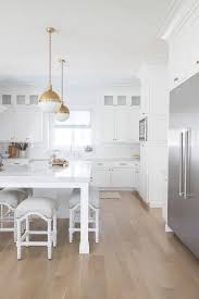 white kitchen with light oak floors