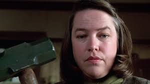 What are the psychological factors behind Annie Wilkes' descent into  madness?