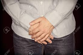 In human anatomy, the groin (the adjective is inguinal, as in inguinal canal) is the junctional area (also known as the inguinal region) between the abdomen and the thigh on either side of the pubic bone. The Man Stands With Arms Crossed At Groin Level On Black Isolated Stock Photo Picture And Royalty Free Image Image 91131979