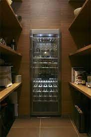The opposite wall contains floor to ceiling bespoke cupboards with storage for everything from tennis rackets to a hidden wine fridge. Pantry With Built In Wine Fridge Incredible Use Of Space Where Else Would You Store Your Wine Wine Fridge Built In Wine Cooler Kitchen Design