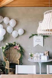 Boho Mama To Be Seating Area Modern Boho Baby Shower Decor Ideas Balloons Florals And Garland Baby Shower Chair Boho Baby Shower Modern Baby Shower