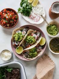 In a medium bowl, combine soy sauce, lime juice, 1 tablespoon canola oil, garlic, chili powder, cumin and oregano. Carne Asada Tacos A Cozy Kitchen