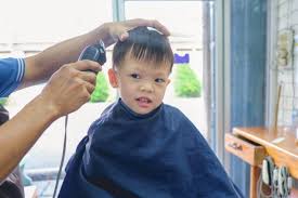 Premium Photo Cute Smiling Little Asian 3 4 Years Old Toddler Boy Child Getting A Haircut At The Hairdresser S Barber Shop Kid Cut With Hairdresser S Machine Top attractive haircuts for boys for 2018 find below most attractive hairstyles haircuts for boys especially for next look in 2018.