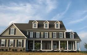 The dark gray vertical board and batten siding on this lake st. Pin By Sheryl Morrissey On Tan Houses With Black Shutters Colonial House Exteriors Tan House Outside House Colors