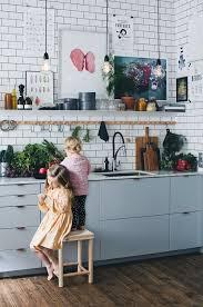 Want a sneak peek into a swedish home kitchen? Gorgeous Swedish Kitchen Inspiration With White Tile Backsplash And The Little Girls Playing In Sweet Babydoll D Kitchen Design Kitchen Interior House Interior