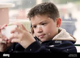 Boy kid child playing with mobile phone Stock Photo