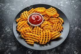 These waffles can be made in a belgian waffle maker to serve 3: Crispy Potato Waffles Fries With Ketchup In A Black Plate Stock Photo Picture And Royalty Free Image Image 104873206