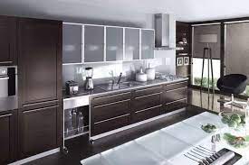 In this kitchen design, modern black cabinets with a glossy finish pair beautifully with a white corian countertop. Modern Glass Design Modern Glass Kitchen Cabinets Novocom Top