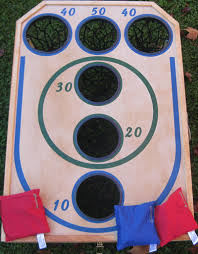 Using the hammer and four nails, attach the 23 piece by pounding 4 nails through it and into the underside of the board. 23 Best Bean Bag Toss Ideas Bean Bag Toss Bag Toss Bean Bag
