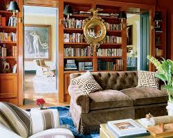 Velvet upholstery in brown color that overflows in pearly undertones impresses with the refinement. Miles Redd Orange Lacquered Library Bookcases With Sconces Brown Velvet Tufted Sofa Federal Convex Mirror Interior Design The Glam Pad