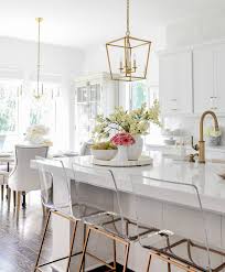 The gold jewelry (hardware, faucet and lighting) sparkles against the polished white carrara marble countertops. Our Bright Inviting Kitchen Reveal Decor Gold Designs
