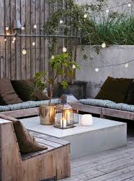 Moderne Terrasse Gestaltungsideen Lichterkette Kerzen Windlichter Hintergarten Garten Lounge Hinterhofbeleuchtung