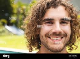 Curly brown hair young man hi-res stock photography and images