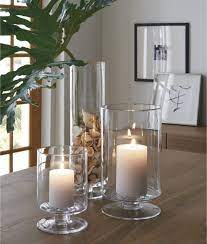 London narrow clear hurricane candle holder + reviews… a crate and barrel classic, these handcrafted glass hurricanes, look as beautiful reflecting candlelight as they do filled with twinkling garlands or terrarium plantings. London Glass Hurricane Candle Holders Crate And Barrel Glass Hurricane Candle Holder Candle Decor Dining Room Table Centerpieces