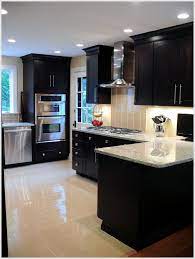The whole kitchen from top to bottom becomes one continuous thing of beauty that is both calm and peaceful. Love The Dark Cabinets And Light Counter Tops And Floor With Stainless Steel In 2020 Kitchen Renovation Kitchen Remodel Kitchen On A Budget