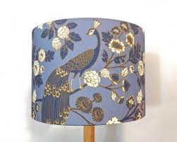 A round lamp shade usually works best for a round base, while a square or angular base looks better with a square lamp shade. Peacock Garden Lampshade By Hello Boho Blue And White Lamp Blue Lamp Shade Peacock Wall Art