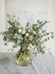 Eucalyptus Ranunculus Bouquet On Emily Alder Tips For Creating A Beautiful Diy Ranunculus And Eucaly Eucalyptus Bouquet Flower Arrangements Wedding Flowers