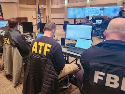Image: Federal law enforcement officials from U.S. Immigration and Customs  Enforcement, the Drug Enforcement Administration, the ATF and the FBI run  an enhanced immigration enforcement operation from the Operations Command  Center in