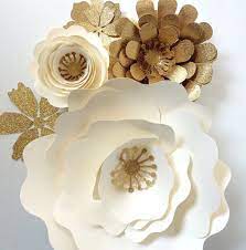 Every flower hanging is so beautiful that it seems like it is really a difficult craft and should try something easy but in contrast, each paper flower is just some paper. Paper Flower Wall Decor Large Paper Flower Backdrop Paper Flowers In Cream And Gold Paper Flowers Diy Paper Flowers Paper Flower Backdrop