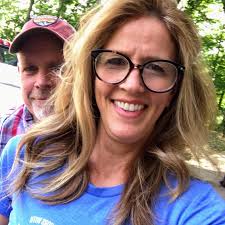 This is a picture of Mike smiling & Melissa with her reading glasses,  wrinkles, double chin with gray roots. & We received a 👎🏼 or negative  review of how they wouldn't recommend