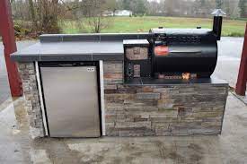 It uses whitewashed brick for a reassuring aged appearance, plus neutral gray accents on the counter. Outdoor Kitchen For The Traeger Pellet Grill Modular Outdoor Kitchens Outdoor Kitchen Countertops Outdoor Kitchen Grill
