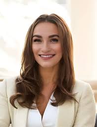 Hey guys, could you please edit my photo and make it look more professional  and corporate. ( Keep her clothes the same) Thank you in advance