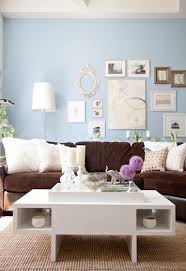 The ceiling and upper walls are bathed in white so it has a light and airy look. Brown Blue Living Room Brown Sofa Brown Sofa Living Room Brown Couch Living Room Brown Living Room