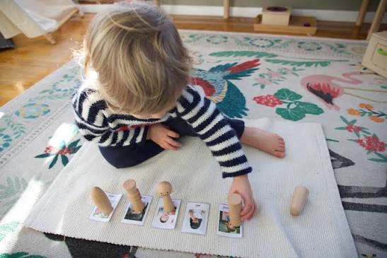 Young child completing a Montessori hands-on activity
