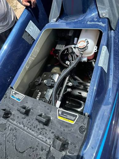 Mechanic servicing watercraft engine
