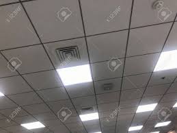 Gold leafing a false ceiling is another way of adorning it and it also adds an element of luxurious living. White Calcium Silicate Square Grid Suspended False Ceiling Work For An Office In An High Rise Buildings For Large Office Spaces With Led Lighting For Better Reflection Stock Photo Picture And Royalty
