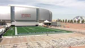 The hot summer days are brutal for players and fans, so the roof was a celebrated feature. Watch Crew Roll Super Bowl Field Into Stadium