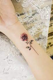 A rose tattoo can signify promise, fresh beginnings, strength, power, peace and even a tribute to the dead. 33 Rose Tattoos And Their Origin Symbolism And Meanings Rose Tattoos On Wrist Tattoo Designs Wrist Single Rose Tattoos