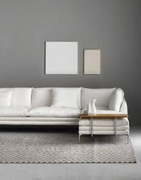 Zanotta monobloc sofa, entirely covered with full grain blue leather, resting on four black lacquered metal legs. William