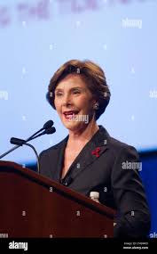 U.S. first lady Laura Bush, 2nd left, accompanied by the wife of U.S.  Ambassador to Japan Susanne Schieffer, left, attends a Japanese tea  ceremony performed by a school girl, right, of the
