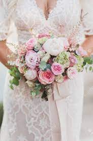 Maybe you would like to learn more about one of these? Bride Holding In Hands Small Wedding Bouquet In Pastel Colors Stock Photo Picture And Royalty Free Image Image 139162445