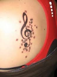 The tattoo design on the side of lower stomach steals the show. Treble Clef With Stars Tattoo Music Tattoo Designs Tattoo Designs For Women Tattoos