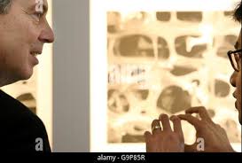 Senior Vice-President of Business Development for the Denver Broncos, Mac  Freeman (R) talks to Broncos Executive Vice-President of Operations John  Elway at Sports Authority Field at Mile High in Denver