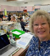 Grade 4 students enjoy reading with Grade 1 class