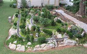 With family coming down from michigan, we set out buildings, started the waterfall and put trains on the track. The Sandflea And Redbud Garden Railway Is Located Behind The Cottage Garden Trains Garden Railway Garden Railroad
