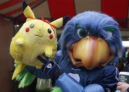Blitz The Seattle Seahawks Mascot Poses For A Photo With Pikachu From Pokemon Seahawks Mascot Seattle Seahawks Mascot