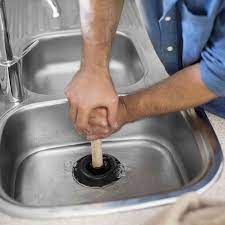 A sink plunger and a drain auger. How To Unclog A Sink Drain