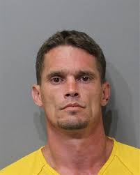 Man held at gunpoint, charged with battery