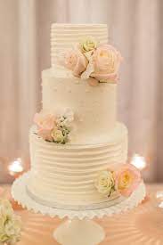 Decorated with fondant ribbons, white gumpaste roses, and purple cascading blossoms that were supposed to give the impression of wisteria. Wedding Trend Milk Glass Romantic Wedding Cake Buttercream Wedding Cake Beautiful Wedding Cakes