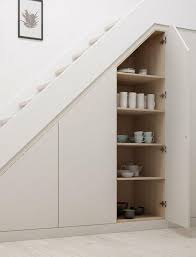 Storage pantries slide out from under the stairs to show off shelves that can house most any sized food items. 31 Living Room Under Stairs Storage Ideas Shelterness