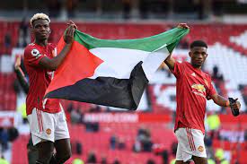 Manchester united star paul pogba took a palestinian flag from the crowd after a premier league match at old trafford on tuesday in a show . More Footballers Back Palestine As Man Utd S Pogba Diallo Display Flag Daily Sabah