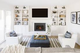 The mantel shelf can be completed with a flower vase or family portrait. White Quartz On Fireplace Hearth Transitional Living Room