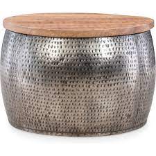 Complement your existing furniture with a light, medium, or dark wooden this coffee table leans into its coastal farmhouse look with natural wood finishes and a mixed material design. Powell D1241a19s Royce Drum Coffee Table W Storage In Silver Wood