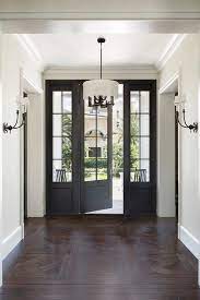 parket houten vloeren met zwarte deur overgang entree foyer black interior doors french doors exterior foyer design