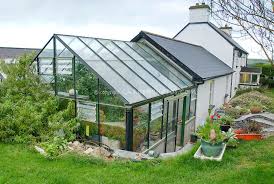 The door is attached toward the end when the plastic was already installed on the hoops. Greenhouse Attached To House Joy Larkcom S Ireland Greenhouse Attached To House Green House Design Home Greenhouse